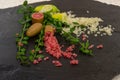 Delicious white and pink citrus caviar with a ripe fruits and green sprigs on the black slate slab, close-up. Australian finger Royalty Free Stock Photo