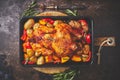 Delicious whole chicken cooked with pumpkin, pepper and potatoes. Served in metal baking pan. Royalty Free Stock Photo