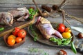 Delicious wild partridge with fresh juicy vegetables on the wooden rustic table. Russian cuisine