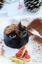 Delicious winter chocolate cake with figs in a plate, a fork cacao decoration and a greeting card Royalty Free Stock Photo