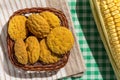 Delicious yellow cookie of corn on basket and corn cob. Sweet food of Festa Junina, a typical brazilian party. Royalty Free Stock Photo