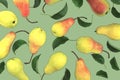 Delicious yellow ripe pears with leaf on pink background. Beautiful pattern. Modern and geometric design. Top view. Food pattern Royalty Free Stock Photo