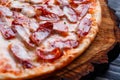 Delicious yummy fresh pizza with bacon, salami, ham and pepperon Royalty Free Stock Photo