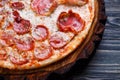 Delicious yummy fresh pizza with bacon, salami, ham and pepperon Royalty Free Stock Photo