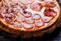 Delicious yummy fresh pizza with bacon, salami, ham and pepperon Royalty Free Stock Photo