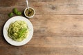Delicious zucchini pasta with basil and pesto sauce served on wooden table, flat lay. Space for text Royalty Free Stock Photo