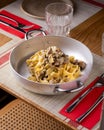 Deliciously arranged table with pappardelle with mushrooms and sausage