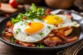 Deliciously cooked fried egg with crispy bacon sizzling in a frying pan top view perspective Royalty Free Stock Photo