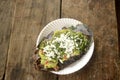 Mexican tlacoyos, a dish made with blue corn and filled with fried beans or broad beans, similar to mexican gordita, with guacamol Royalty Free Stock Photo