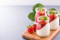 Delicous and nutritious double color colour strawberry desserts with mint and diced sarcocarp topping with airy blue