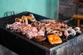 Delicous seafood grilling on ember stove close up. Street food at night in Vietnam