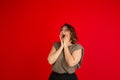 One young Caucasian beautiful woman in casual style isolated on bright red background.