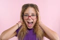 Delight, happiness, joy, victory, success and luck. Teen girl on a pink background. Royalty Free Stock Photo