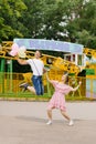 Delighted adult couple is having fun together in an outdoor amusement park during their leisure time. The concept of the lifestyle Royalty Free Stock Photo