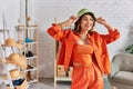 delighted asian designer in orange clothes