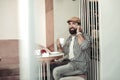 Delighted bearded man having a phone conversation