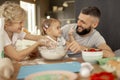 Delighted bearded man smiling to his daughter