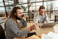 Delighted bearded man working in the office