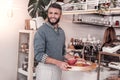 Delighted cheerful man holding a tray with breakfast Royalty Free Stock Photo