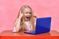 Delighted child at laptop. online training. emotional little girl. concept idea Royalty Free Stock Photo