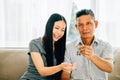 A delighted couple celebrates new homeownership displaying keys to their house Royalty Free Stock Photo