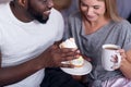 Delighted couple eating cupcakes together Royalty Free Stock Photo