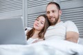 Delighted couple watching a film together