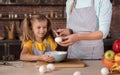 Delighted daughter cooking with her mother in the kitchen