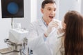 Delighted ENT doctor examining sore throat Royalty Free Stock Photo