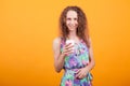 Delighted female in summer dress holding a cup of coffee