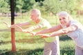 Delighted friends doing exercises in the park