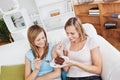 Delighted friends eating a chocolate cake at home