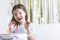 Delighted girl and birthday cake