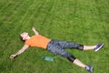 Delighted girl sitting in the park after workout