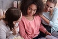 Delighted girls discussing the magazine at the home party Royalty Free Stock Photo