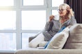 Delighted good looking woman enjoying her tea