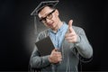 Delighted graduate pointing you