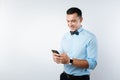 Delighted handsome man using modern device Royalty Free Stock Photo