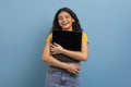 Delighted young indian woman hugging laptop with blank screen Royalty Free Stock Photo