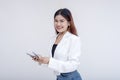 A delighted and joyful young woman looking at the camera while counting money. Isolated on a white background Royalty Free Stock Photo