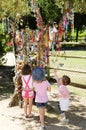 Happy Kids Looking at Colorful Pacifiers on Olive Tree Royalty Free Stock Photo