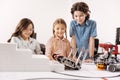 Delighted kids testing cyber robots at school