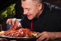 Delighted man eating crayfishes in restaurant Royalty Free Stock Photo