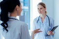 Delighted medical worker listening her assistant Royalty Free Stock Photo