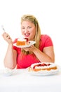 Delighted overweight woman with cream cakes