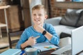 Delighted positive boy pointing at his smartwatch Royalty Free Stock Photo