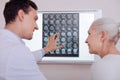 Delighted positive doctor looking at his patient Royalty Free Stock Photo