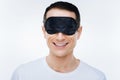 Delighted positive man wearing a sleeping mask