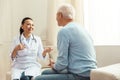 Delighted positive nurse talking to her patient Royalty Free Stock Photo