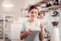 Delighted positive woman enjoying her coffee